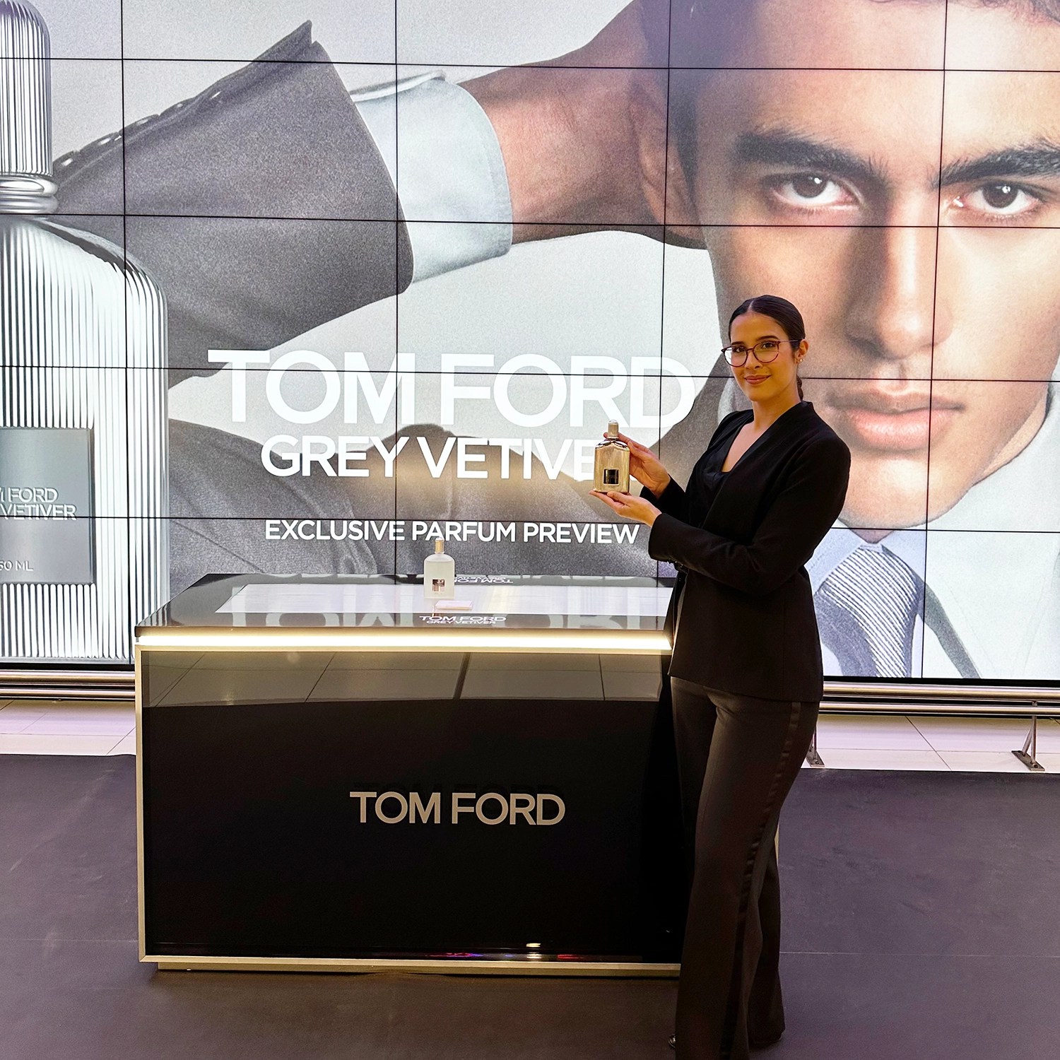 Tom Ford brand ambassador engaging with travelers in airport retail